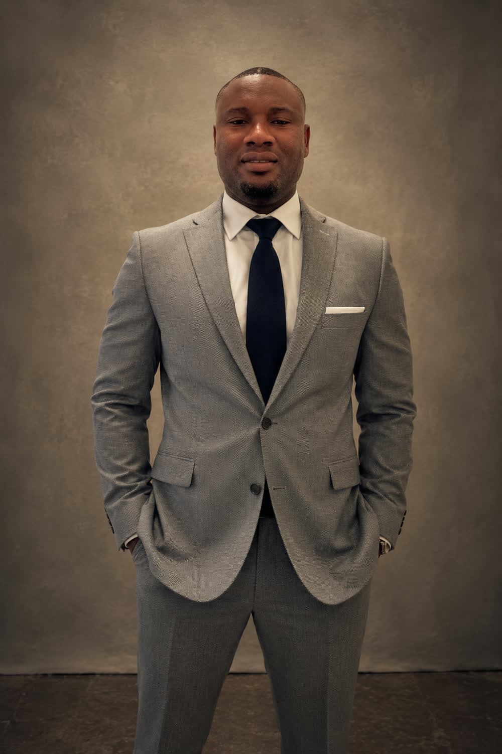 Percy Adjei Laryea, founder of ProAct Legal Solutions, in a light gray suit and navy tie